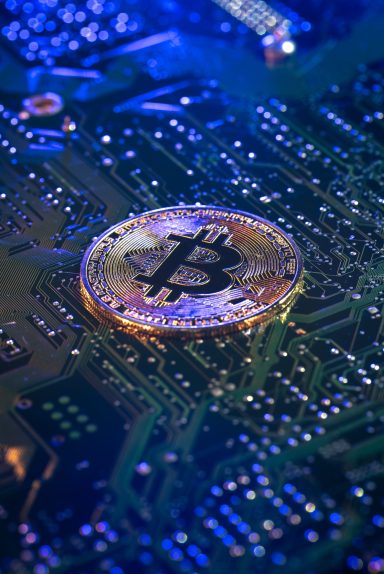 Bitcoin coin close-up on circuit board. Finance concept. High quality photo